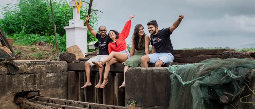 The image shows couples in Goa exploring the Divar Island on their long weekend in Goa