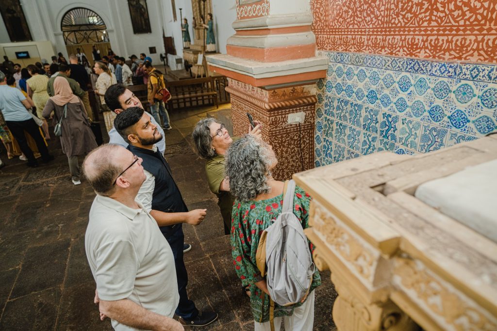 The image shows a group of people on a heritage walking tour in Old Goa