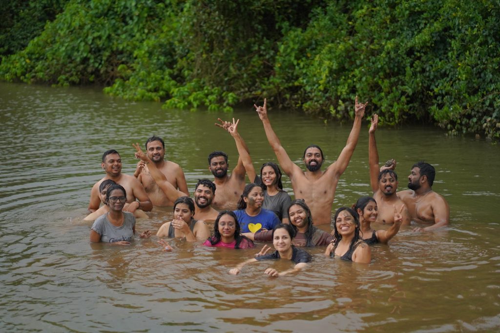 the image shows a group of friends enjoying clay bath goa