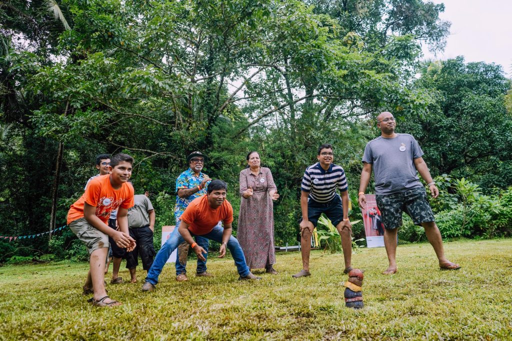 The image shows a family or a corporate team in Goa on a vacation playing Games of Goa