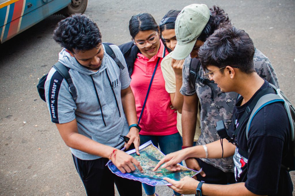 The image shows a group of friends on a treausure hunt in Goa