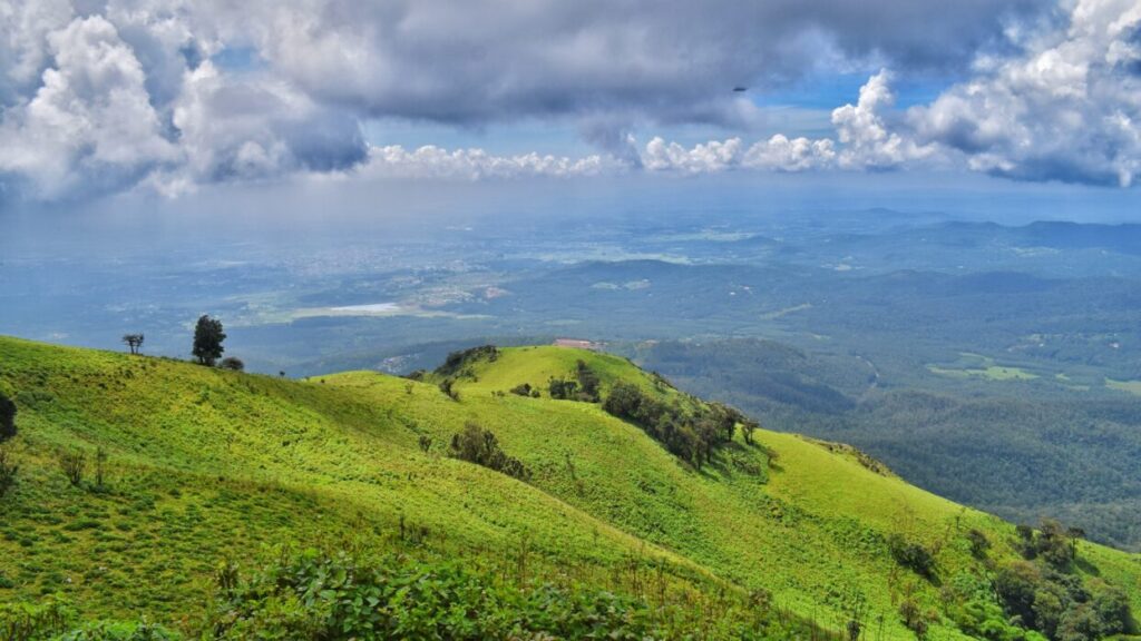 Places to Visit in India: Green hills at Coorg,India with a beautiful view of the low lands. 